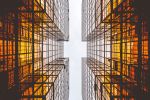 Looking up at modern glass buildings